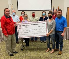 DDA presents check